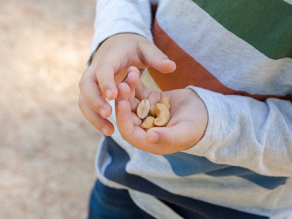 child holding peanuts